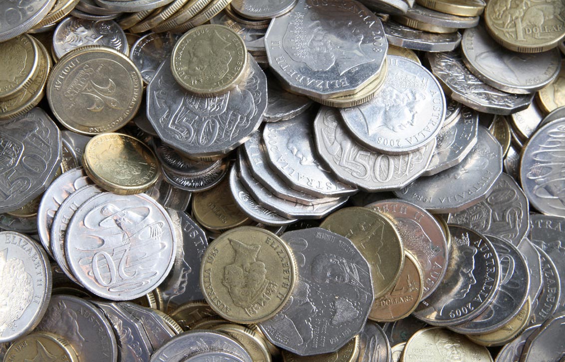 Australian dollar coins scattered on table